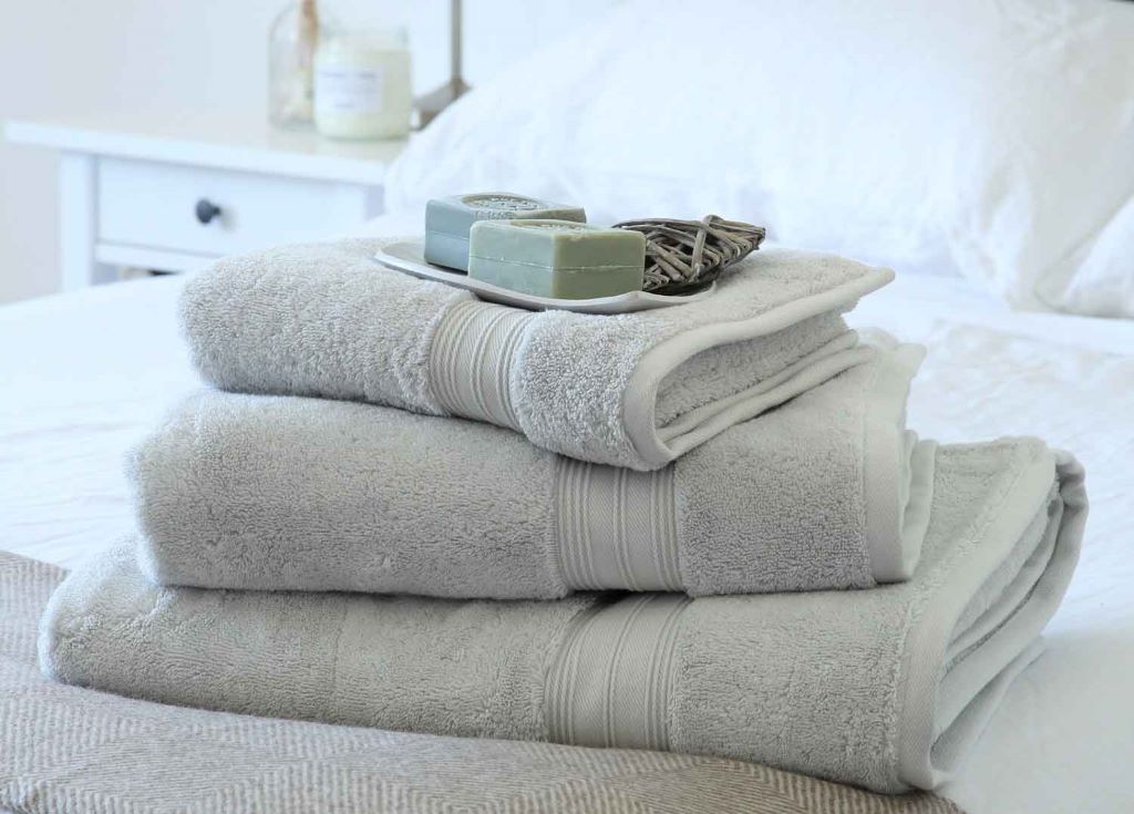 Stack of soft affordable bath towels folded neatly in a bathroom